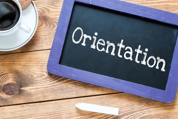 Orientation handwritten on blackboard — Stock Photo, Image