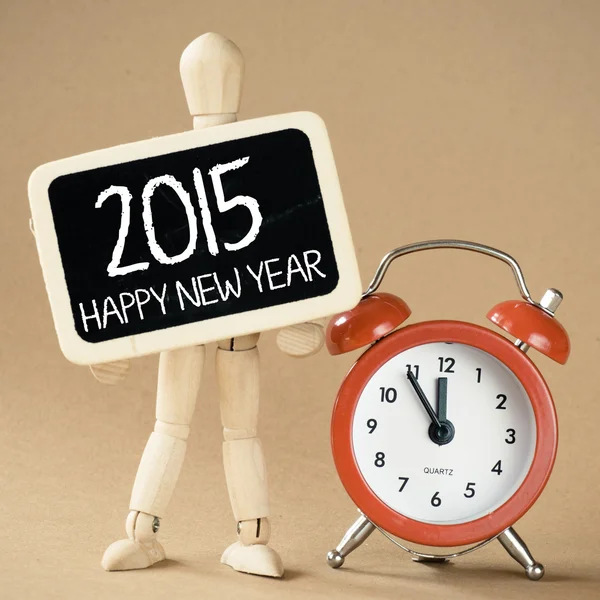 A wooden man holds a slate and clock — Stock Photo, Image