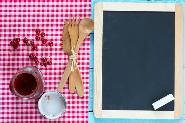 Blackboard on wooden surface — Stock Photo, Image