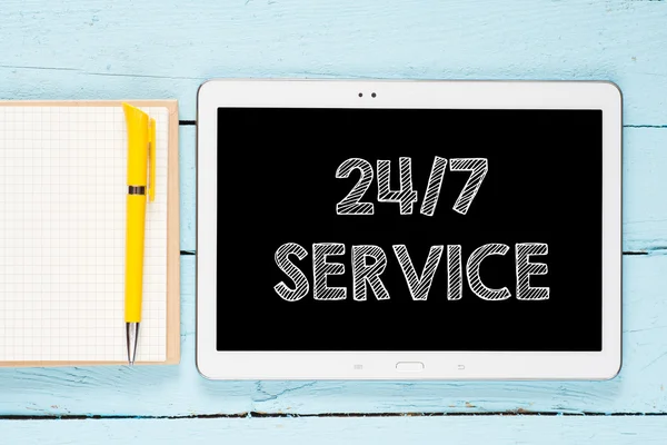 Tablet PC with words 24-7 service — Stock Photo, Image