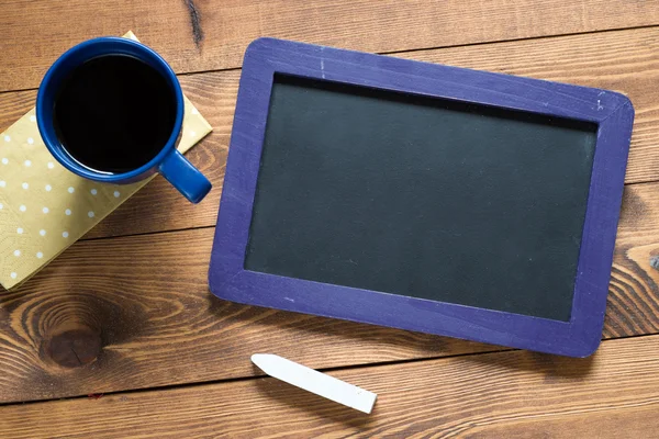 Small wooden framed blackboard with cup of coffee — Stock Photo, Image