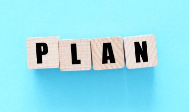 PLAN word on wooden blocks and a blue background.