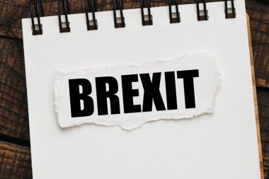 BREXIT word written on a small piece of paper.
