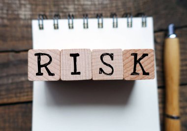 RISK word composed of wooden blocks.                               