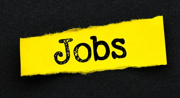 Parola Jobs Piccolo Pezzo Carta Giallo Uno Sfondo Nero — Foto Stock