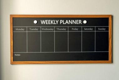WEEKLY PLANNER. Magnetic board with the days of the week. Place to enter important matters. Concept for business.