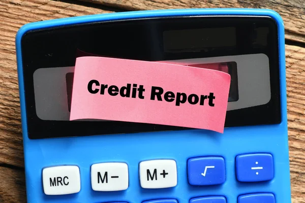 Credit Report words on a small piece of paper lying on the calculator.