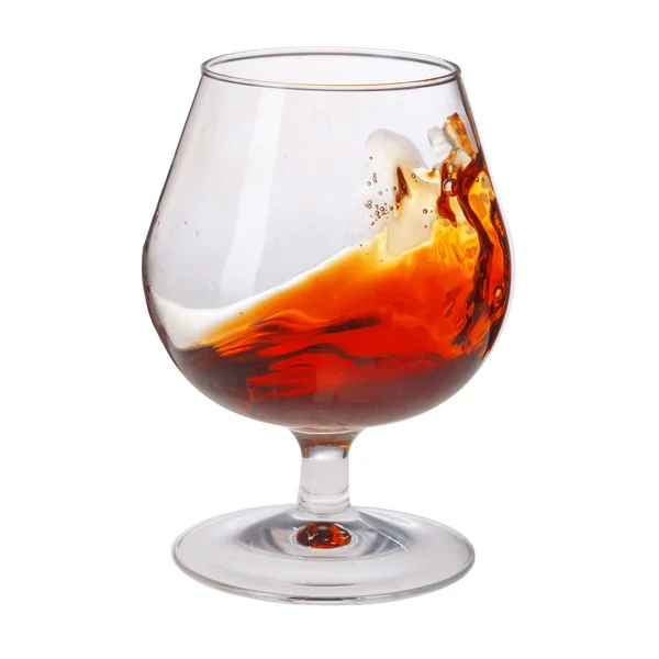 Splash of cognac in glass on white background — Stock Photo, Image