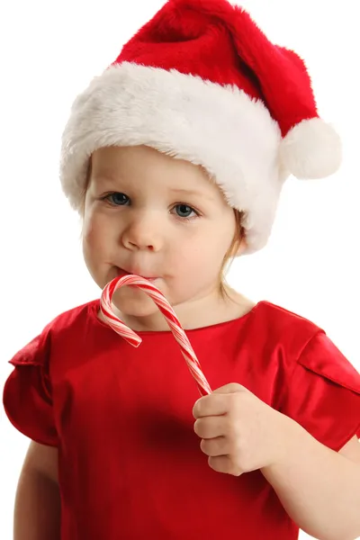 Close up of little girl licking a candy cane — Stock Photo, Image