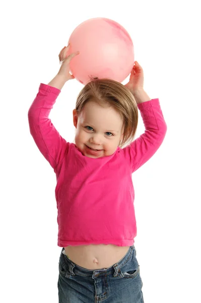 Young girl holding ball showing navel — Stock Photo, Image