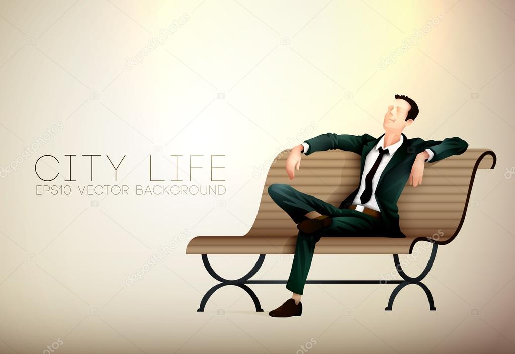 Young business man taking a relaxing break on a bench