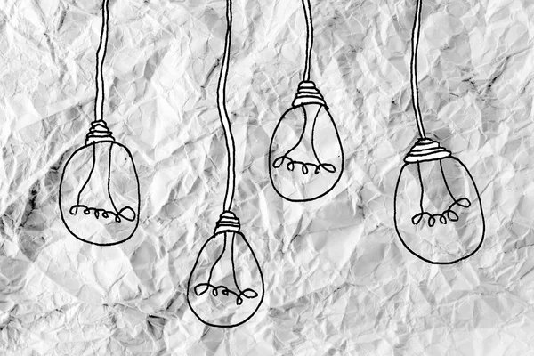 Idea concept light bulb on crumpled paper — Stock Photo, Image