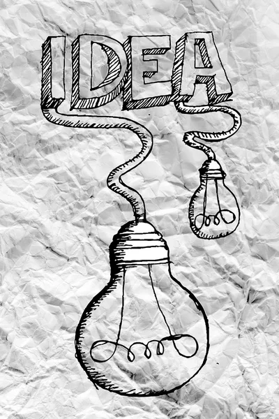 Ideia conceito lâmpada sobre papel amassado — Fotografia de Stock