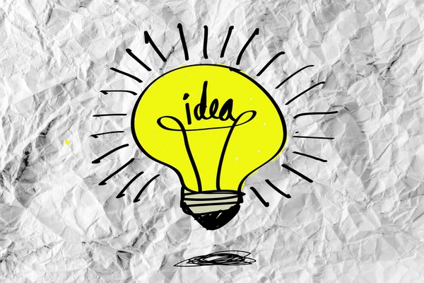 Idea concept light bulb on crumpled paper — Stock Photo, Image