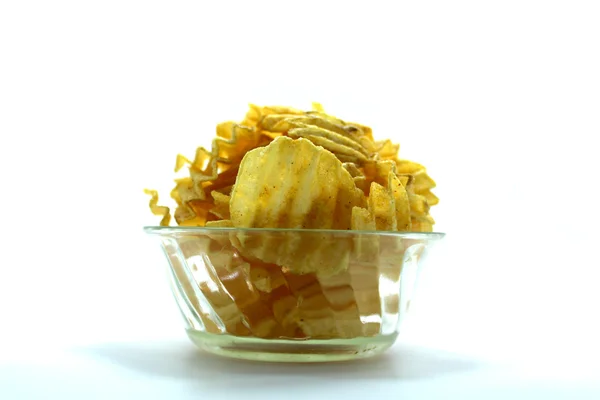 Вкусные картофельные чипсы в миске на белом фоне — стоковое фото
