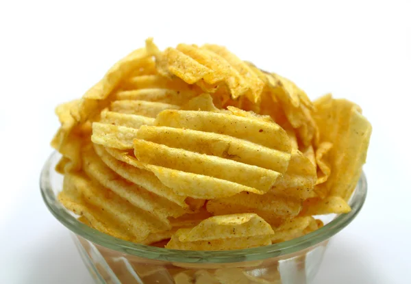 Delicious potato chips in bowl on a white background — Stock Photo, Image