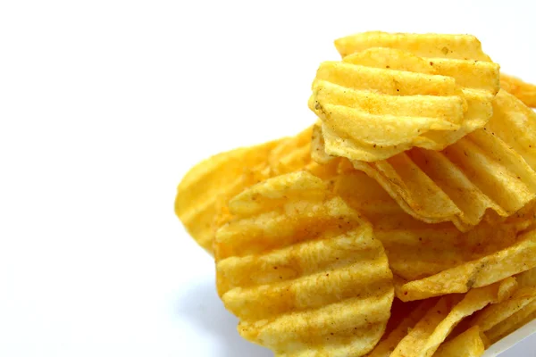 Delicious potato chips in bowl on a white background — Stock Photo, Image