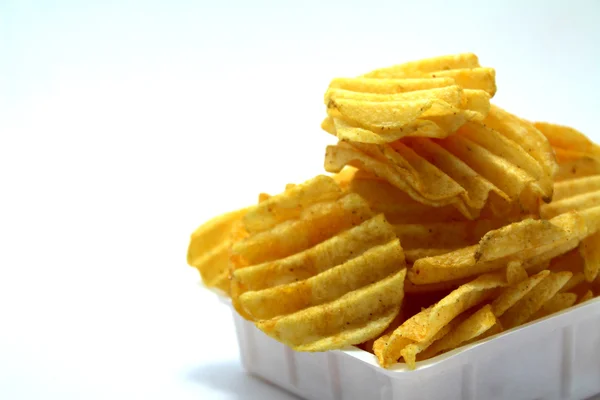Delicious potato chips in bowl on a white background — Stock Photo, Image