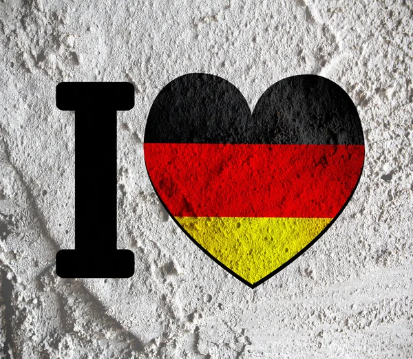 Miłość Niemcy flaga znak serce symbol na ścianie cementu tekstury powrót — Zdjęcie stockowe