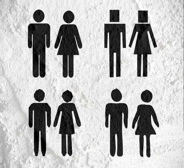 Pictogram man vrouw teken pictogrammen op cement muur textuur achtergrond — Stockfoto