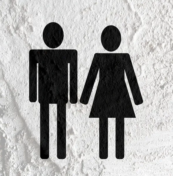 Piktogram man kvinna tecken ikoner på cement vägg textur bakgrund — Stockfoto