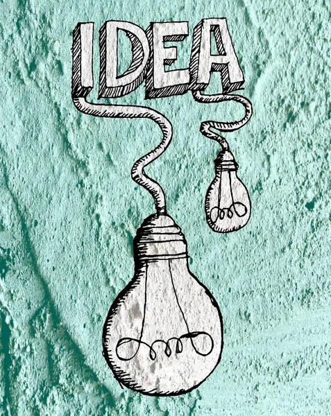 Idea Icono de bombilla en pared de cemento textura fondo diseño — Foto de Stock