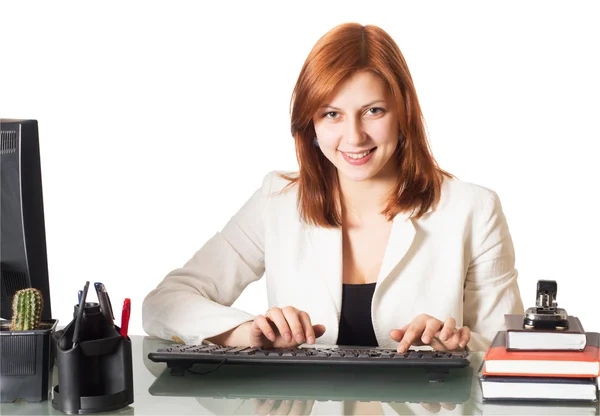 Smiling girl typing on a computer keyboard in the office — Stock Photo, Image