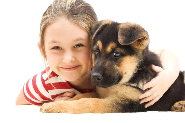 Girl embraces a puppy — Stock Photo, Image