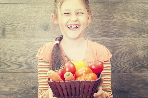 Child holds vegetables — Stock Photo, Image