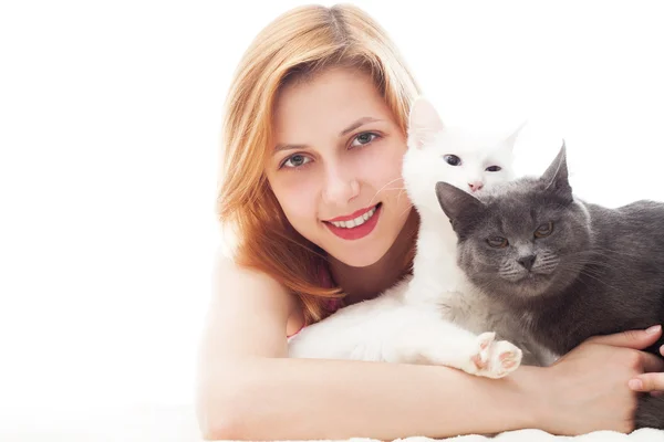 Young girl hugging two cats and cute smiles Stock Image