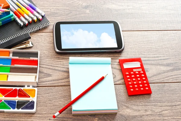 Set of accessories for the modern pupil on a wooden table — Stock Photo, Image