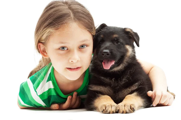 Beautiful little girl and a German Shepherd puppy on white backg — Stock Photo, Image