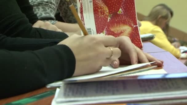 Tangan seorang wanita menulis dengan pena di buku catatan — Stok Video