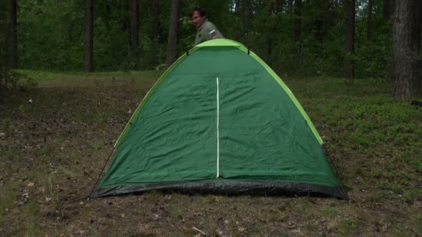 Man toonhoogte een tent in het bos — Stockvideo