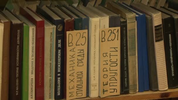 Books on the shelves in the library — Stock Video