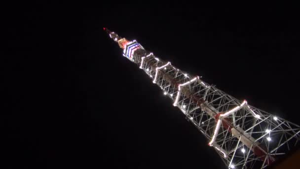 Television tower at night decorated with fires — Stock Video