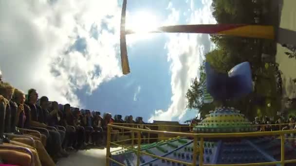 People inside Extreme swing at amusement park — Stock Video