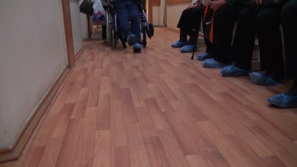 Il paziente in sedia a rotelle nella clinica — 图库视频影像