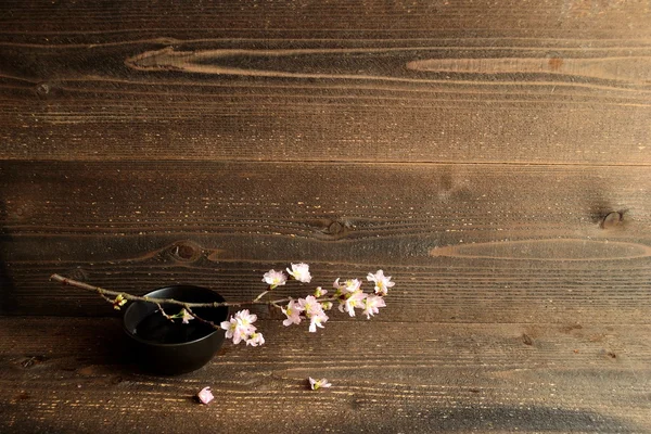 Japanese cherry blossoms on wooden background