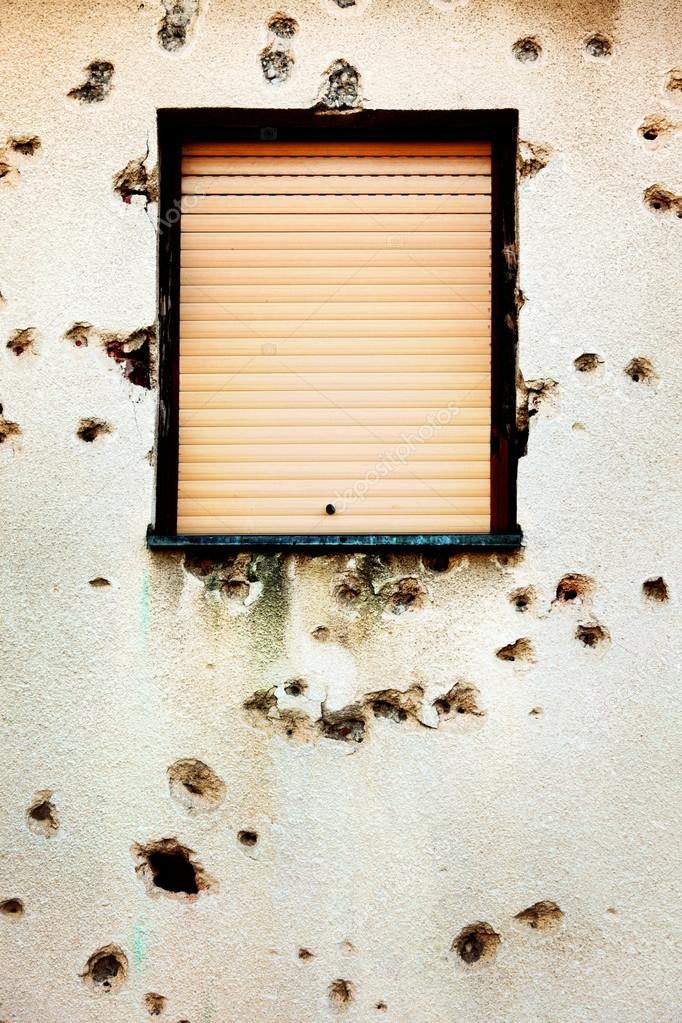 Bullet holes in a house facade