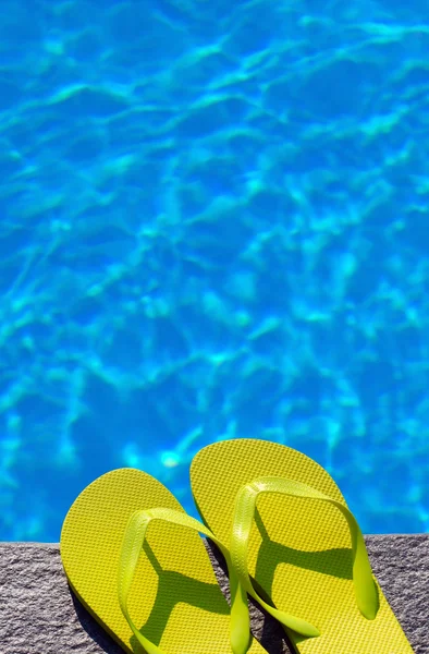 Sandals by a pool — Stock Photo, Image