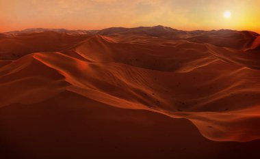 Sand dunes Sahara Desert at sunse
