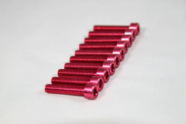 Zócalo / tornillo hexágono anodizado rojo — Foto de Stock