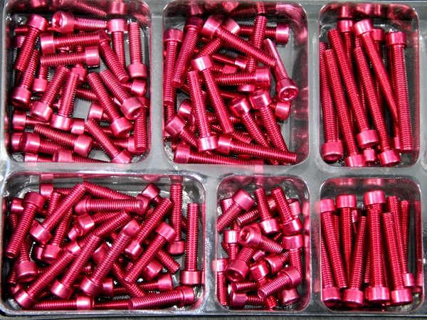 Red anodized hexagon socket / screw — Stock Photo, Image