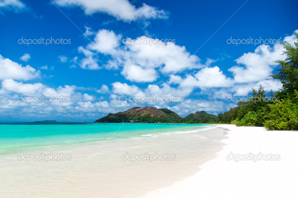 White coral beach sand and azure indian ocean.