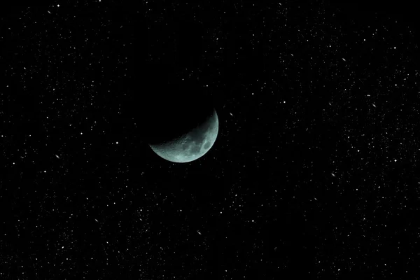 The moon closeup on a background of the starry sky.