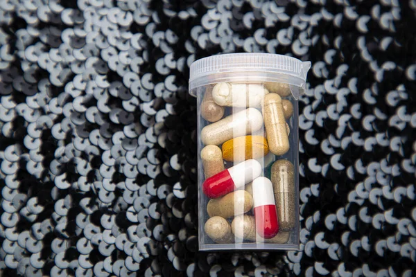 Transparent Bottle Pill Filled Mix Capsule Tablet Black Sequin Background — Foto Stock