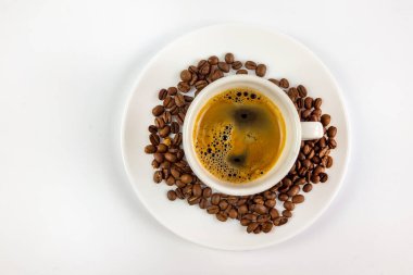 A cup of coffee and coffee beans on white background