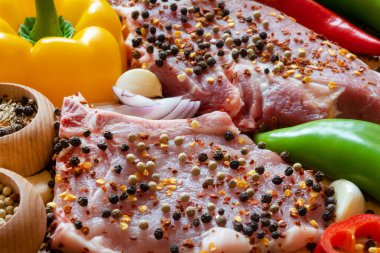 Close up of raw meat steaks with spices 