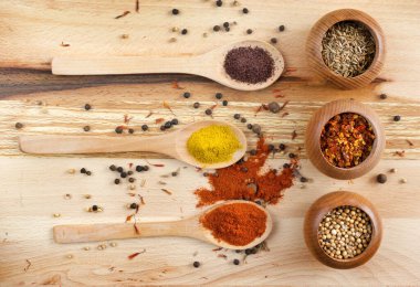 Set of different spices on wooden board